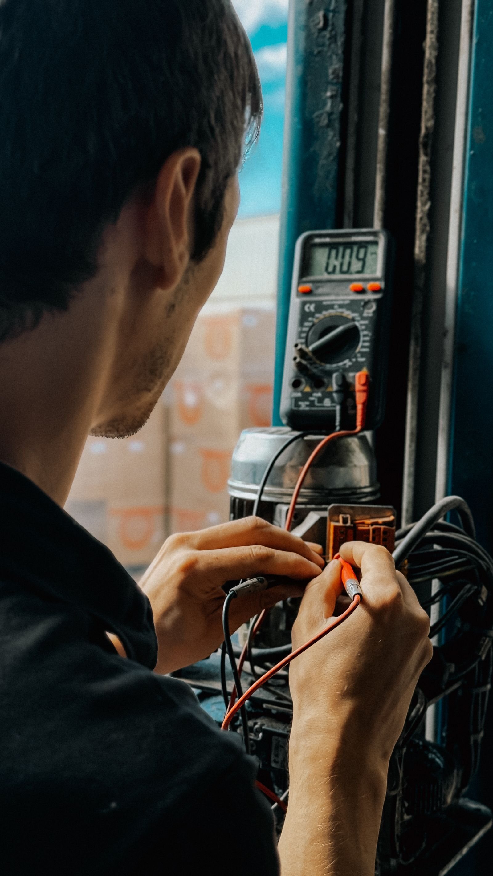 Qualified electrician working with precision instruments