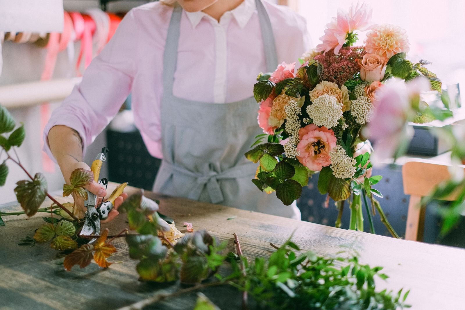Professional florist arranging flowers