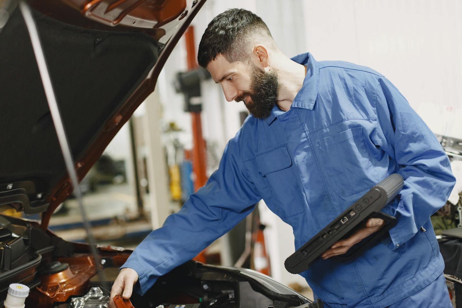 Mechanic servicing vehicle