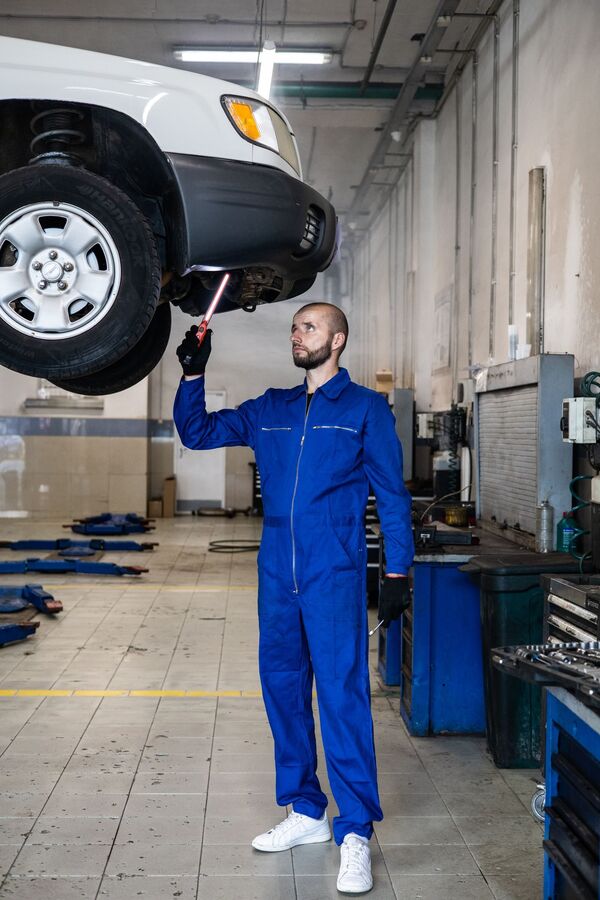 Mechanic servicing vehicle