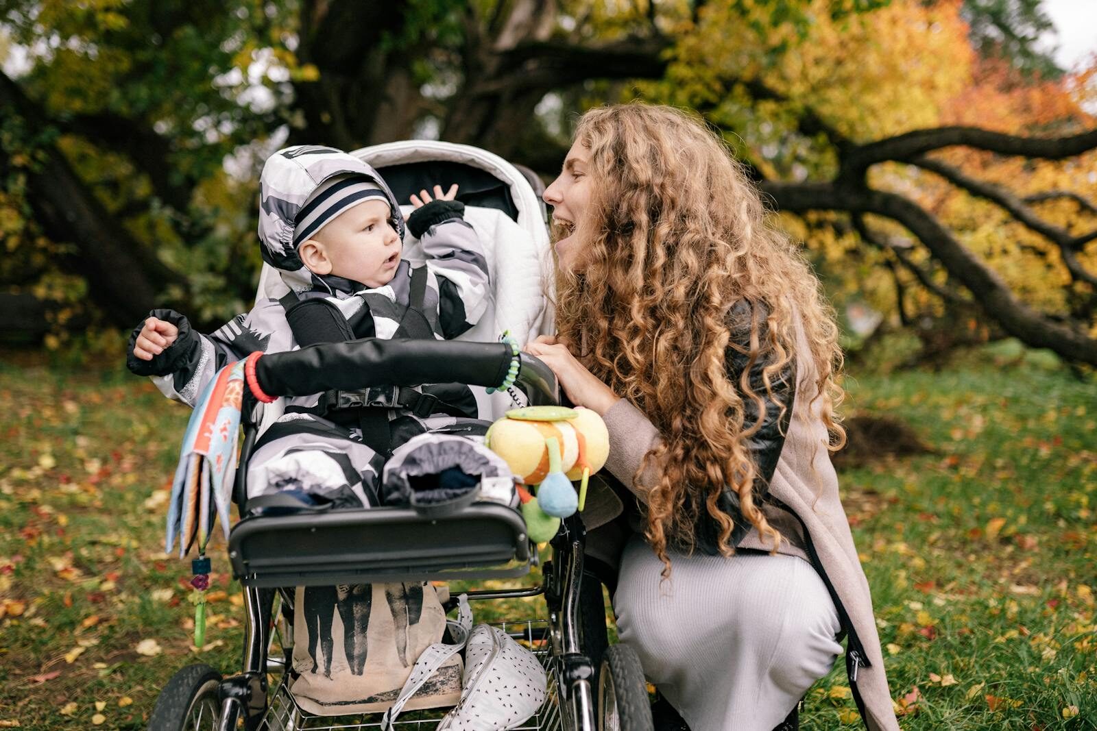 Mother with baby in pram in park