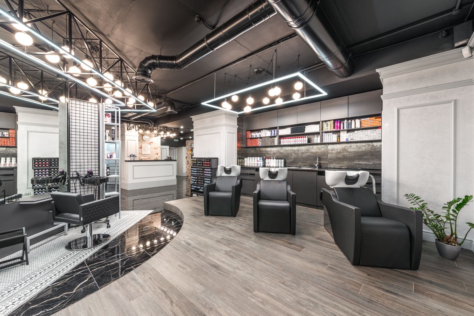 Modern beauty studio interior with styling chairs, mirrors and warm lighting