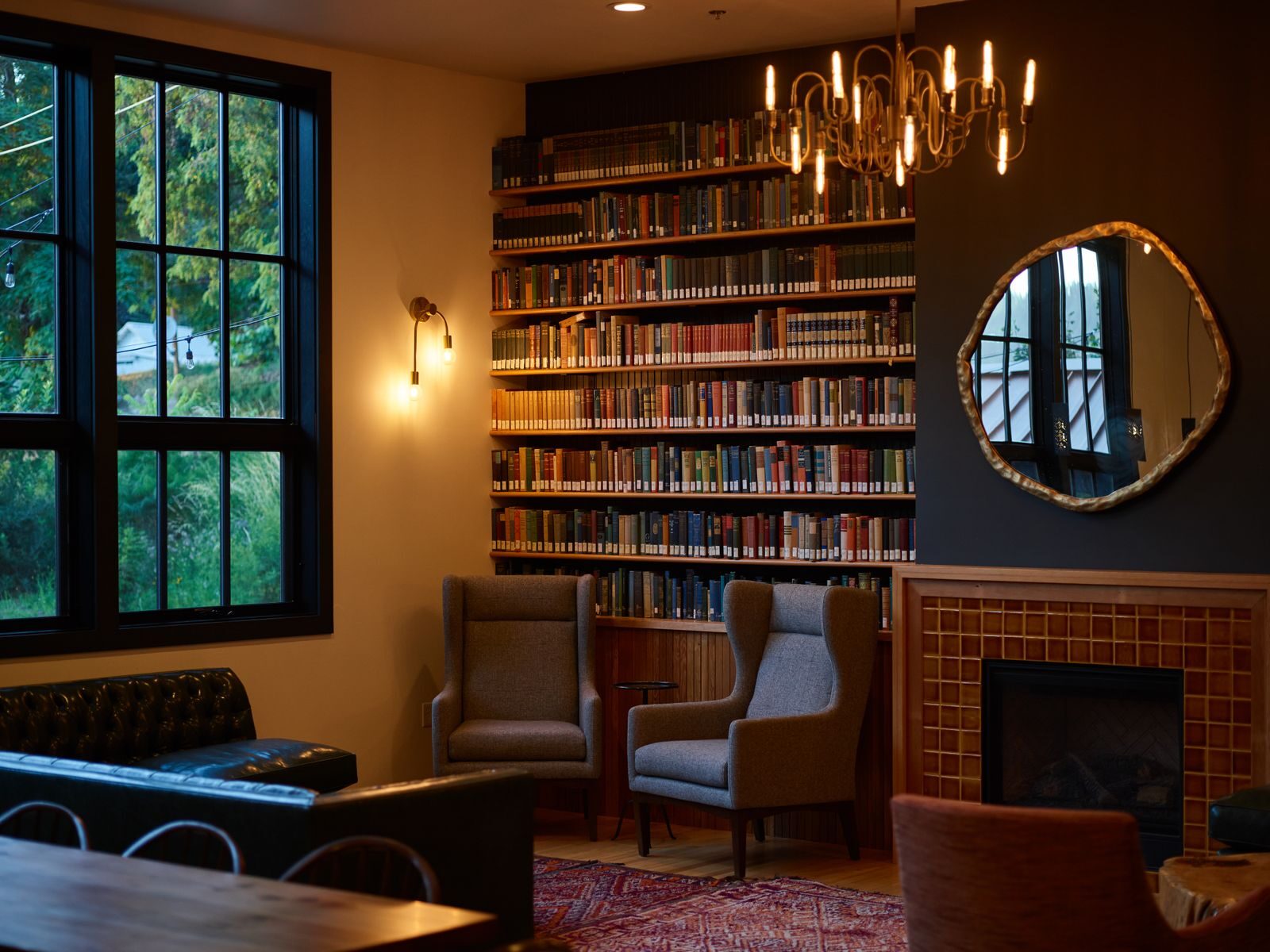 The warm, book-lined sitting room at Llechwen Hall