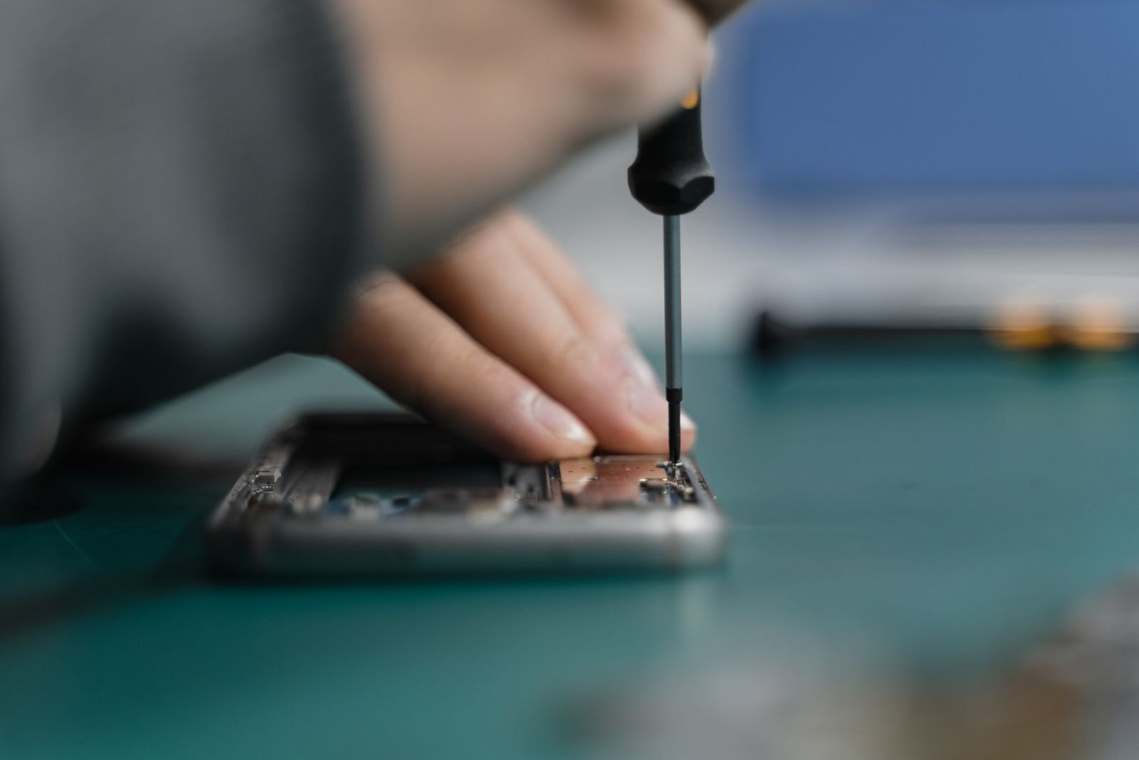 Phone repair technician working on device