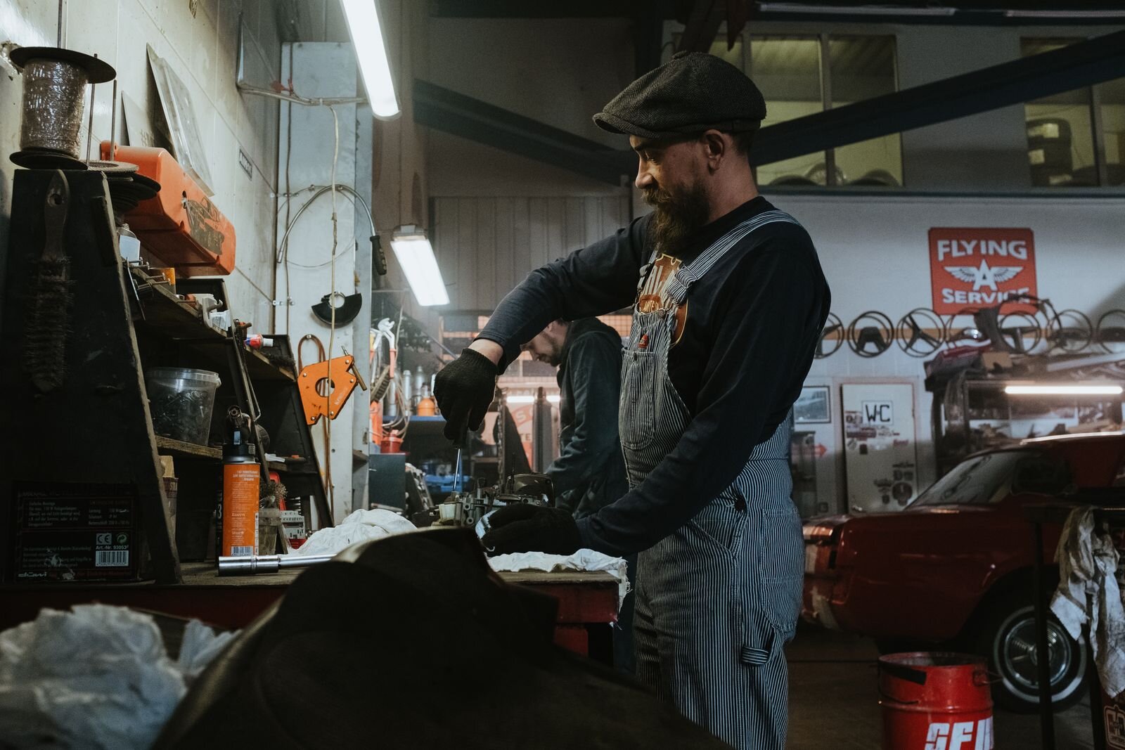 Pages Garage mechanic working on a classic red car