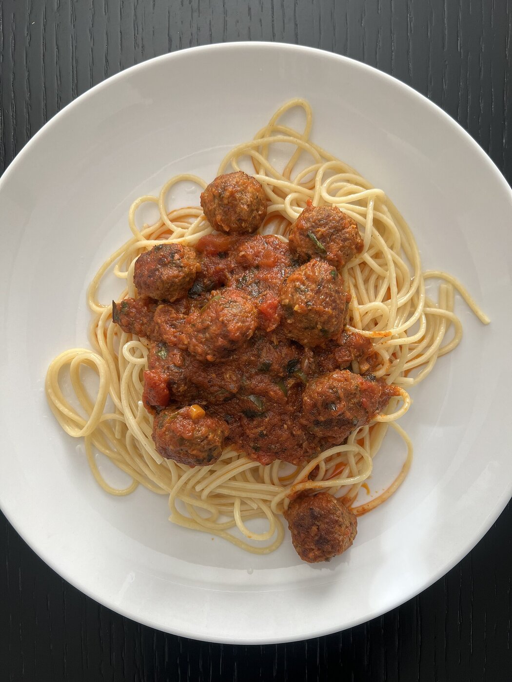 Spaghetti with slow-cooked meatballs in rich tomato sauce